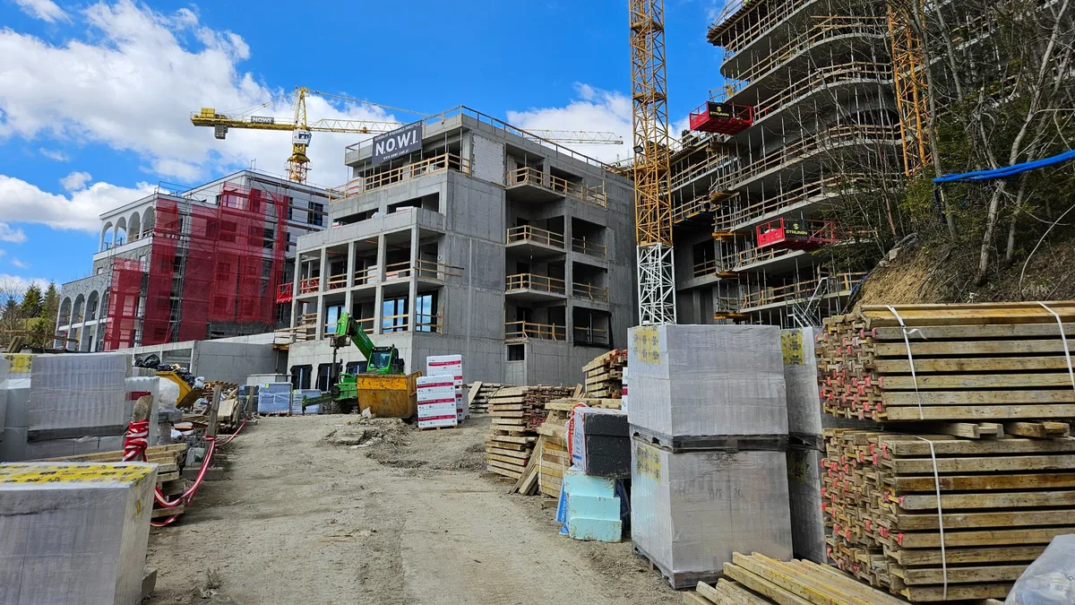 Construction of modern apartment buildings with tower cranes